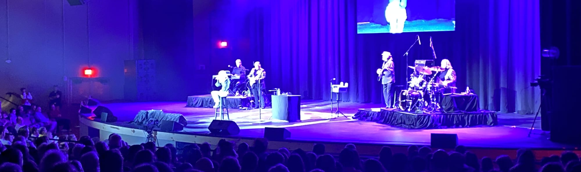 signer on stage in chair washed out by the lights Santa Rosa